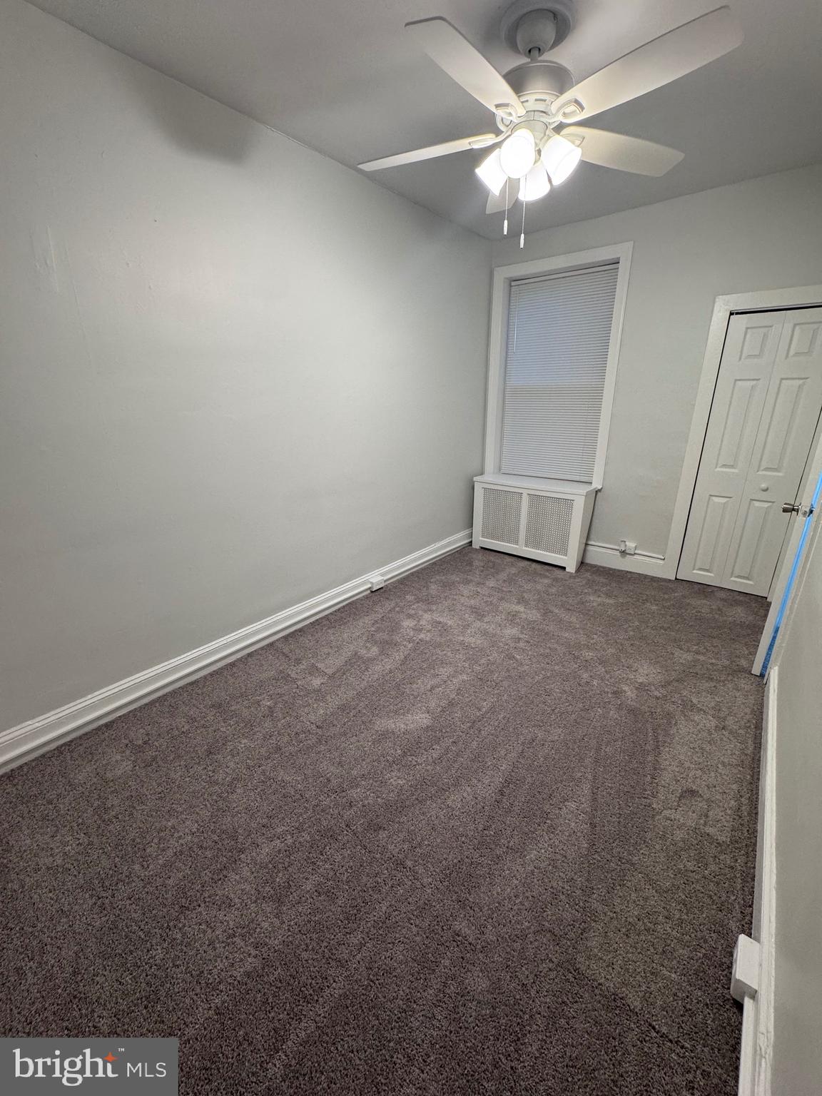 1031 Cantrell Street Philadelphia, PA 19148 - Photo 6 of 10 an empty room with a ceiling fan and carpet