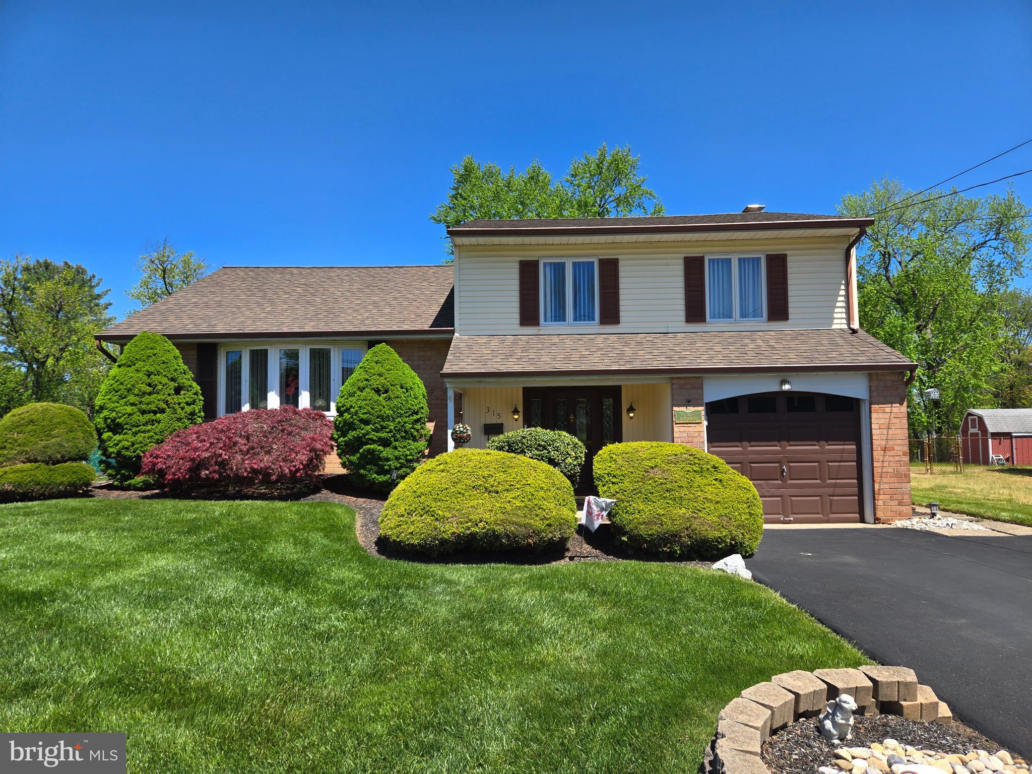 a view of a house with a garden and yard