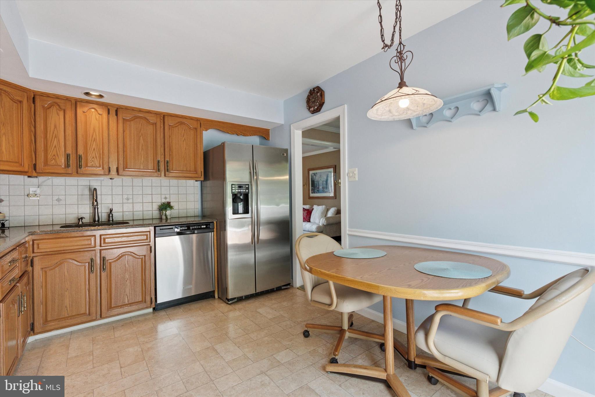 315 Waverly Road Southampton, PA 18966 - Photo 11 of 24 a kitchen with stainless steel appliances a table chairs and chandelier