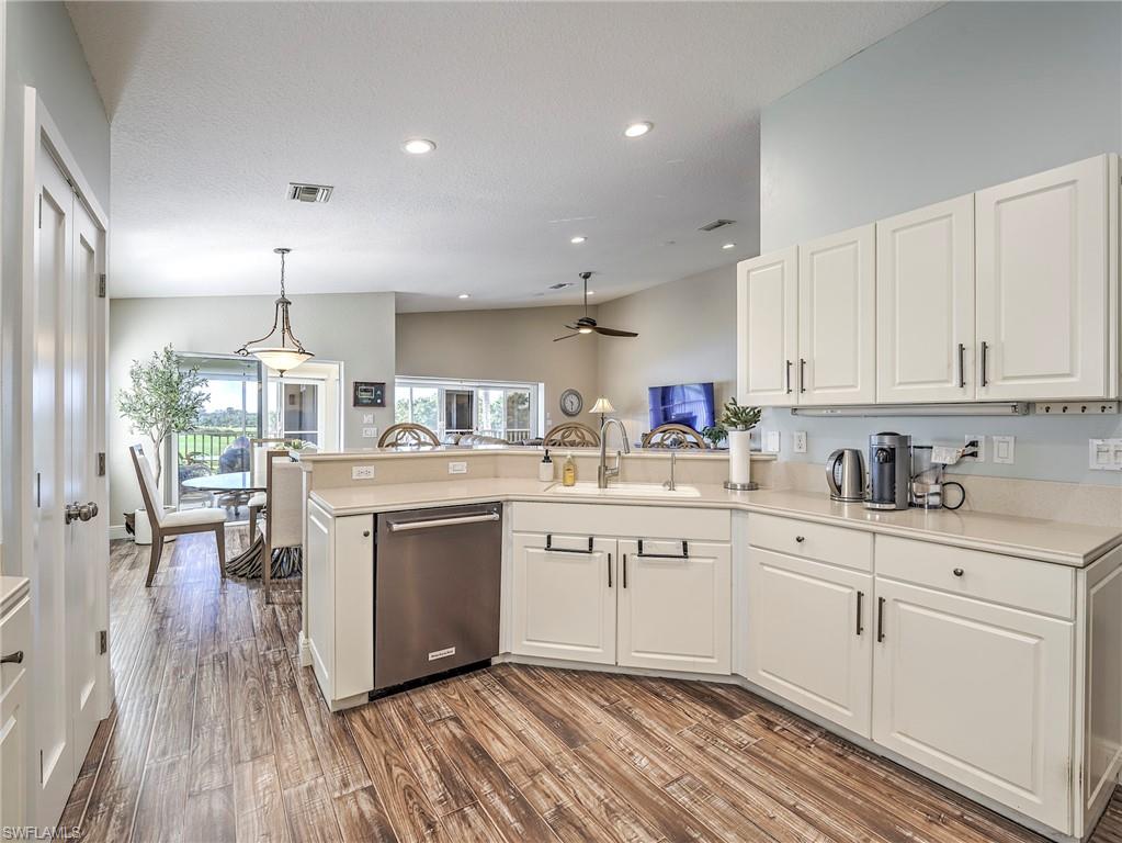 8460 Southbridge Drive, Unit 2 Estero, FL 33967 - Photo 17 of 42 a kitchen with sink cabinets and wooden floor