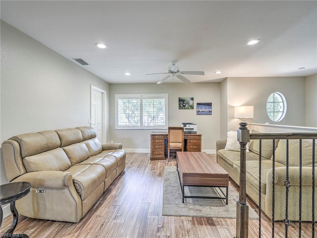 8460 Southbridge Drive, Unit 2 Estero, FL 33967 - Photo 22 of 42 a living room with furniture a fireplace and a window