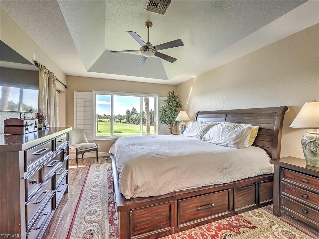 8460 Southbridge Drive, Unit 2 Estero, FL 33967 - Photo 23 of 42 a bedroom with a bed and wooden floor