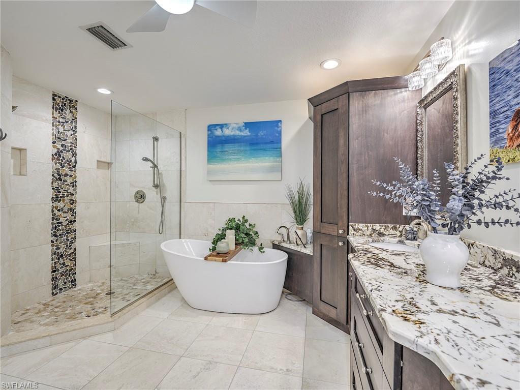 8460 Southbridge Drive, Unit 2 Estero, FL 33967 - Photo 26 of 42 a spacious bathroom with a bathtub and shower