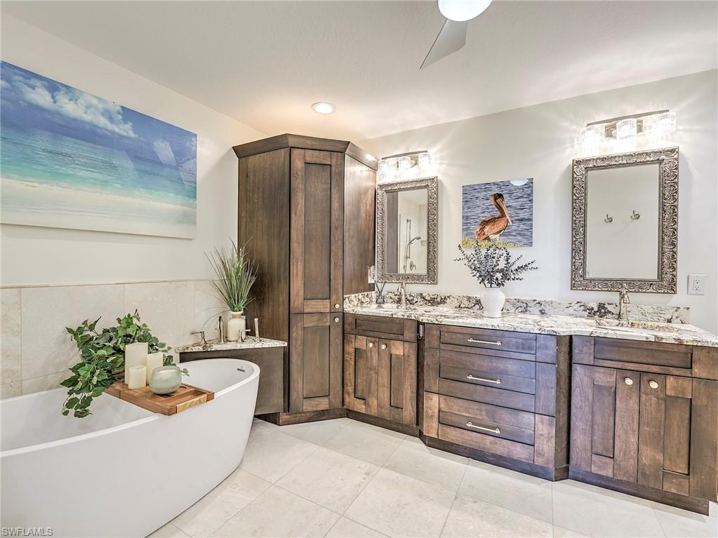 8460 Southbridge Drive, Unit 2 Estero, FL 33967 - Photo 27 of 42 a bathroom with a granite countertop sink and a mirror