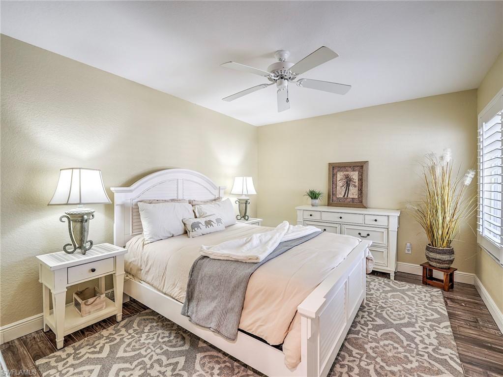 8460 Southbridge Drive, Unit 2 Estero, FL 33967 - Photo 28 of 42 a bedroom with a bed and a chandelier