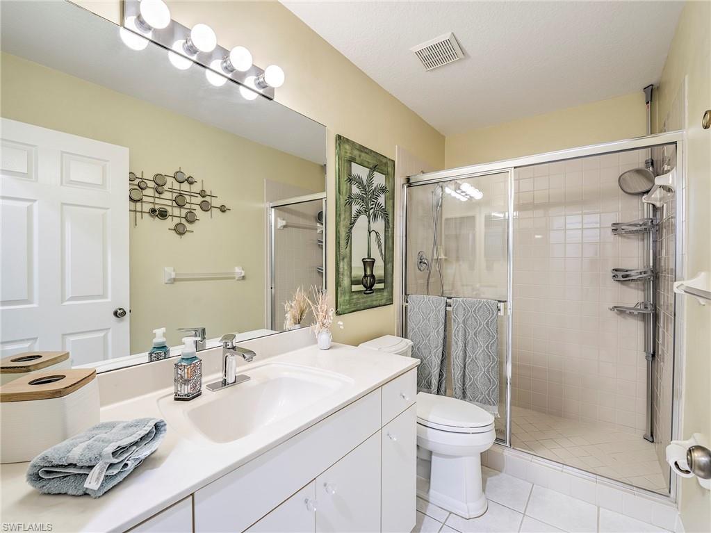 8460 Southbridge Drive, Unit 2 Estero, FL 33967 - Photo 31 of 42 a bathroom with a sink a toilet and shower