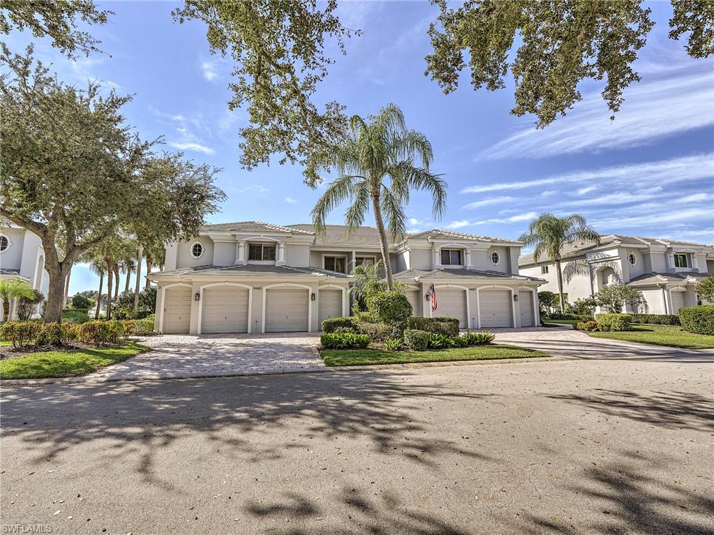 8460 Southbridge Drive, Unit 2 Estero, FL 33967 - Photo 33 of 42 a front view of a house with a yard and garage