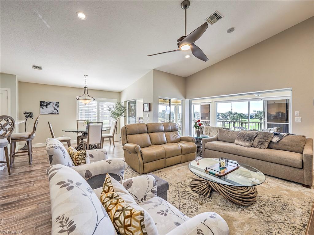 8460 Southbridge Drive, Unit 2 Estero, FL 33967 - Photo 8 of 42 a living room with furniture wooden floor and a large window