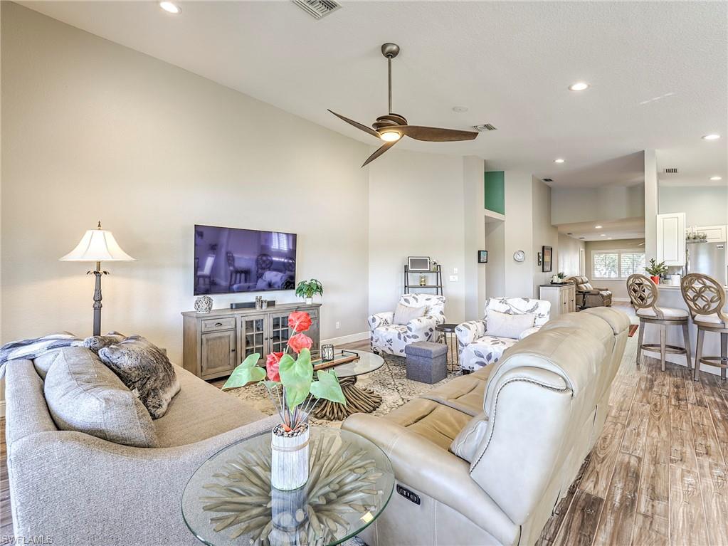 8460 Southbridge Drive, Unit 2 Estero, FL 33967 - Photo 9 of 42 a living room with furniture and a wooden floor