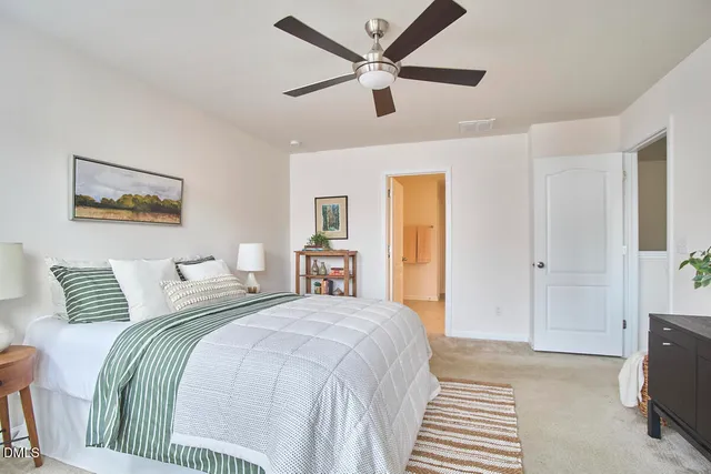 a bedroom with a bed and a painting on the wall