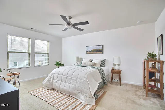 a bedroom with a bed furniture and a large window