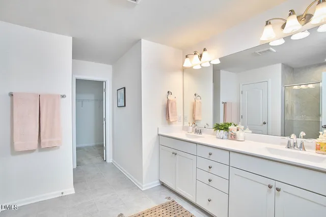 a bathroom with a double vanity sink and a mirror