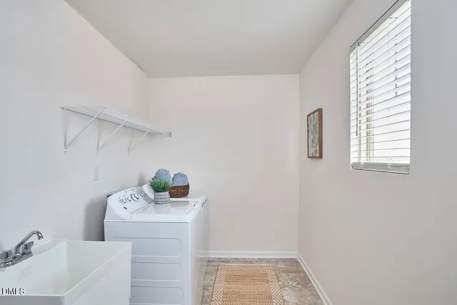 a bathroom with a granite countertop toilet a sink a mirror a shower and a window