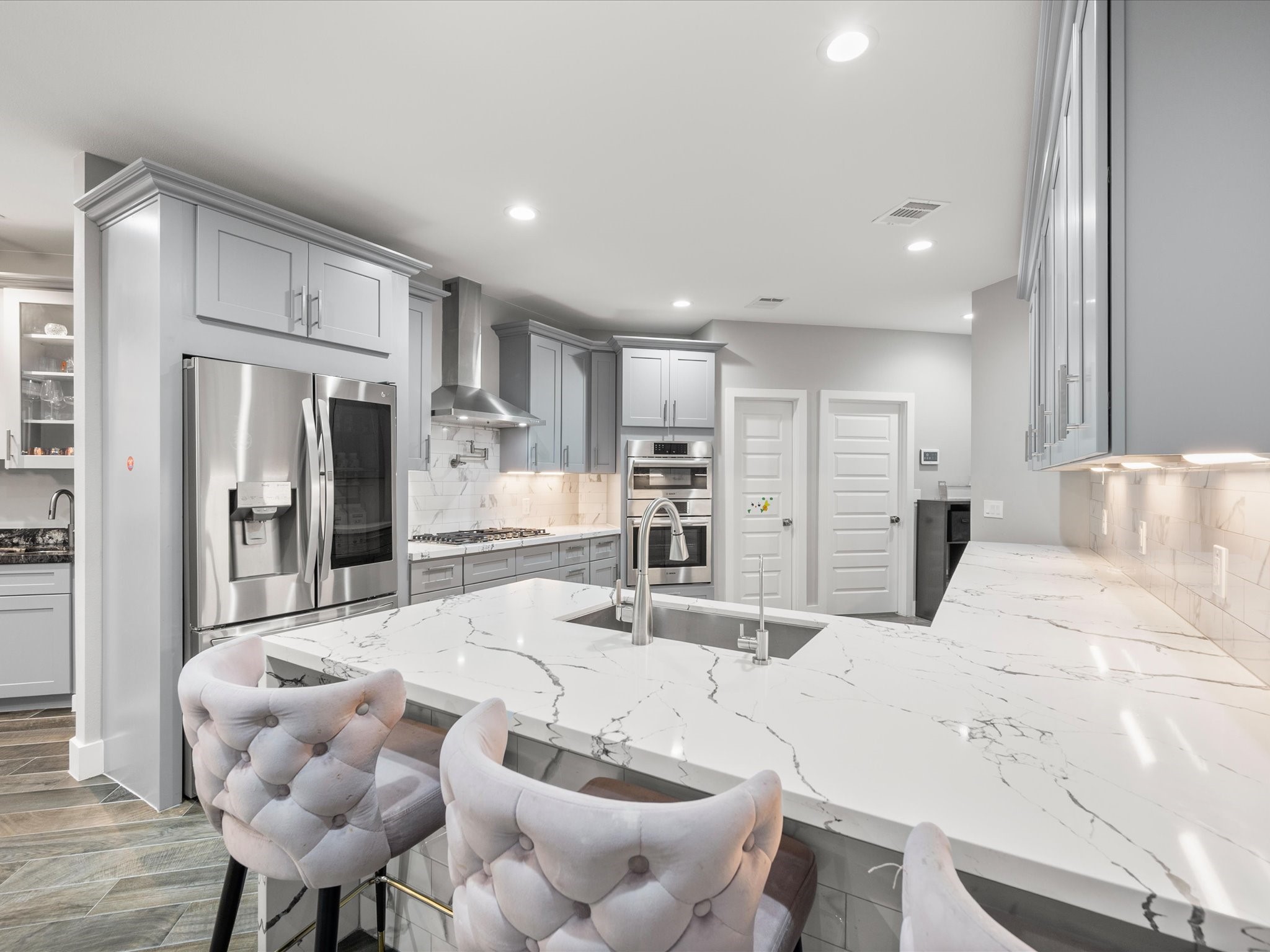 6207 Graff Net Court Spring, TX 77379 - Photo 17 of 48 The chef-inspired kitchen combines style and functionality with waterfall quartz countertops, premium appliances, and thoughtful design details throughout.