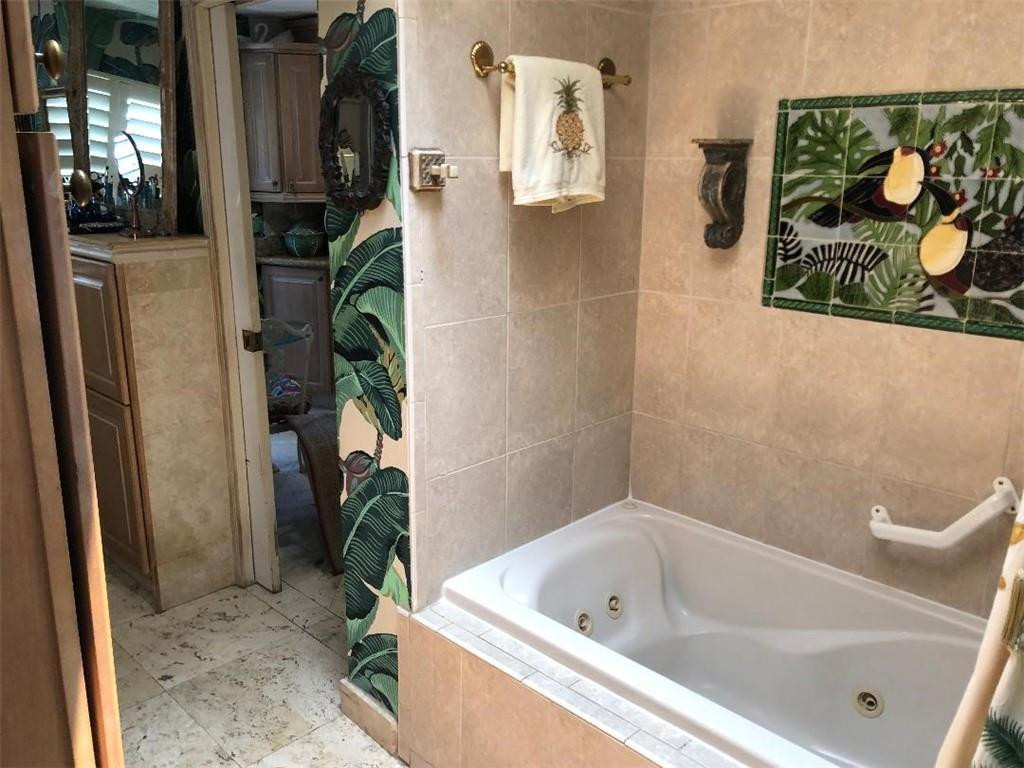 2713 Northeast 30th Avenue Lighthouse Point, FL 33064 - Photo 11 of 22 a bathroom with a tub