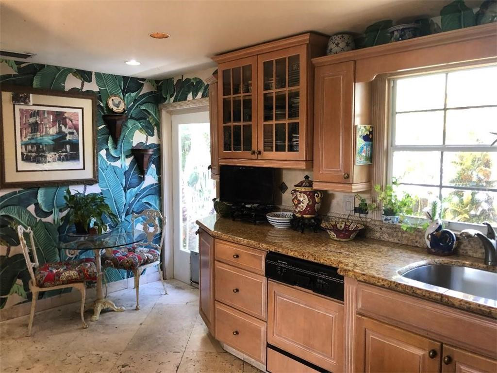 2713 Northeast 30th Avenue Lighthouse Point, FL 33064 - Photo 6 of 22 a kitchen with stainless steel appliances granite countertop a stove a sink and a microwave