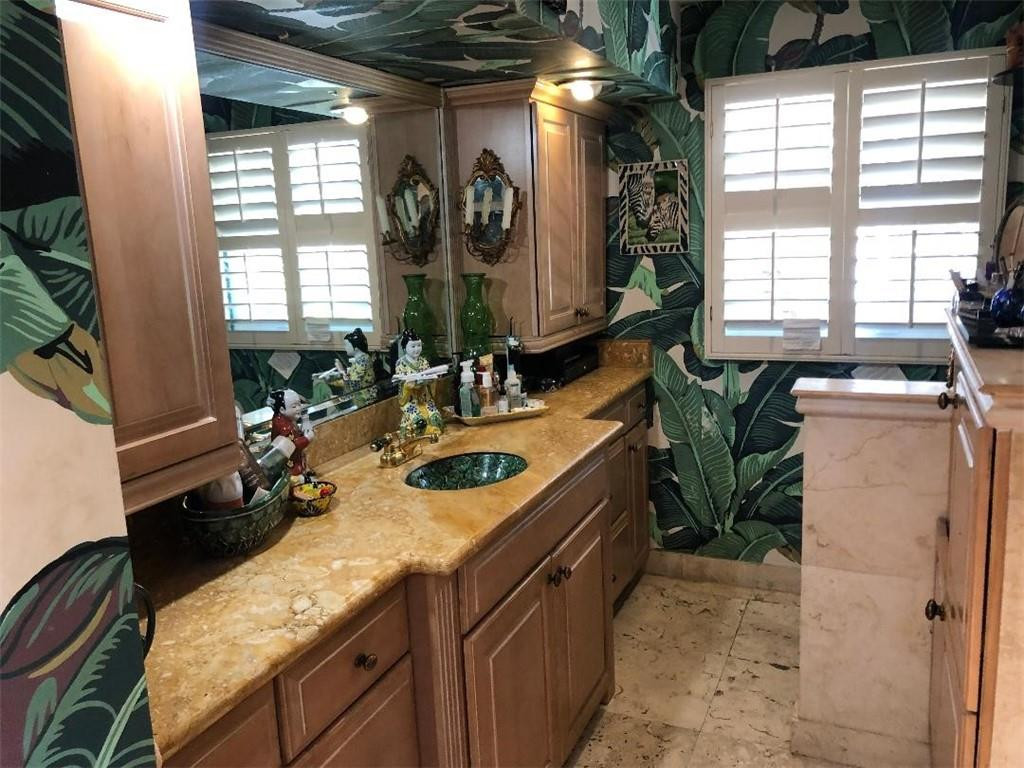 2713 Northeast 30th Avenue Lighthouse Point, FL 33064 - Photo 10 of 22 a bathroom with a granite countertop sink and a large mirror