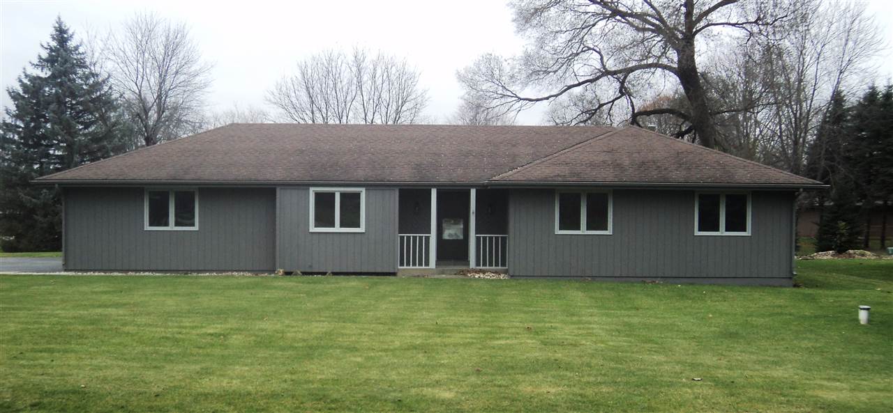 12236 Tresemer Road Roscoe, IL 61073 - Photo 1 of 9 a house that has a tree in front of a house