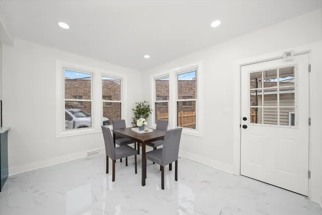 a view of a dining room with a table and chairs