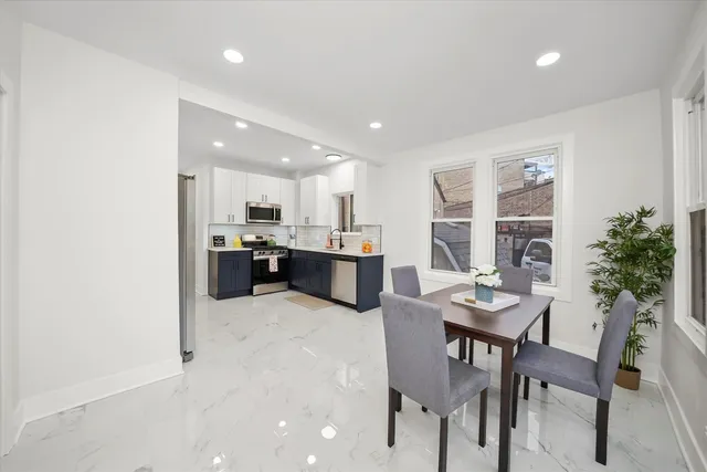 a kitchen with a table and chairs in it