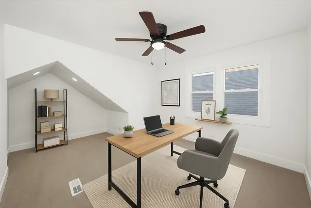 a workspace with a couch and a window