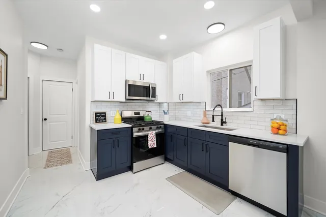 a kitchen with stainless steel appliances granite countertop a refrigerator oven a sink dishwasher and a refrigerator with wooden cabinets