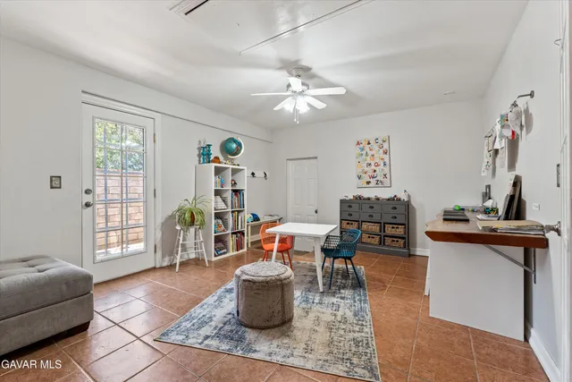 a kitchen with stainless steel appliances granite countertop table chairs sink and cabinets