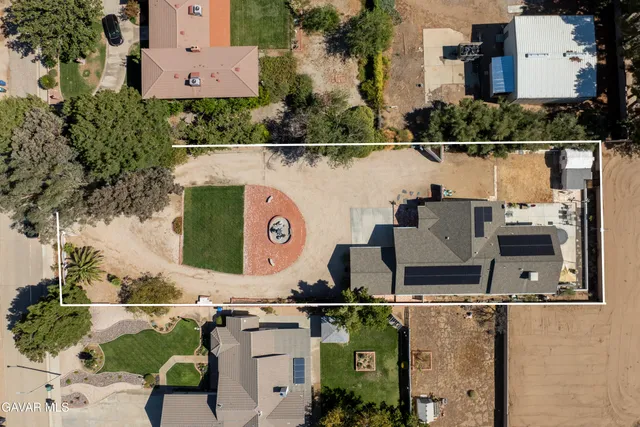 an aerial view of a house with swimming pool and outdoor space