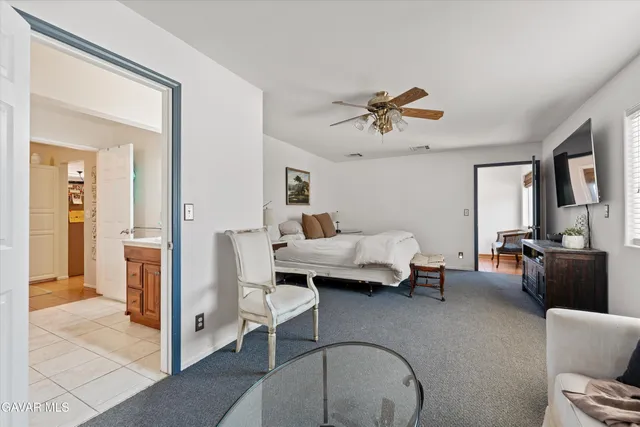 a bedroom with a bed and a tv on the dresser