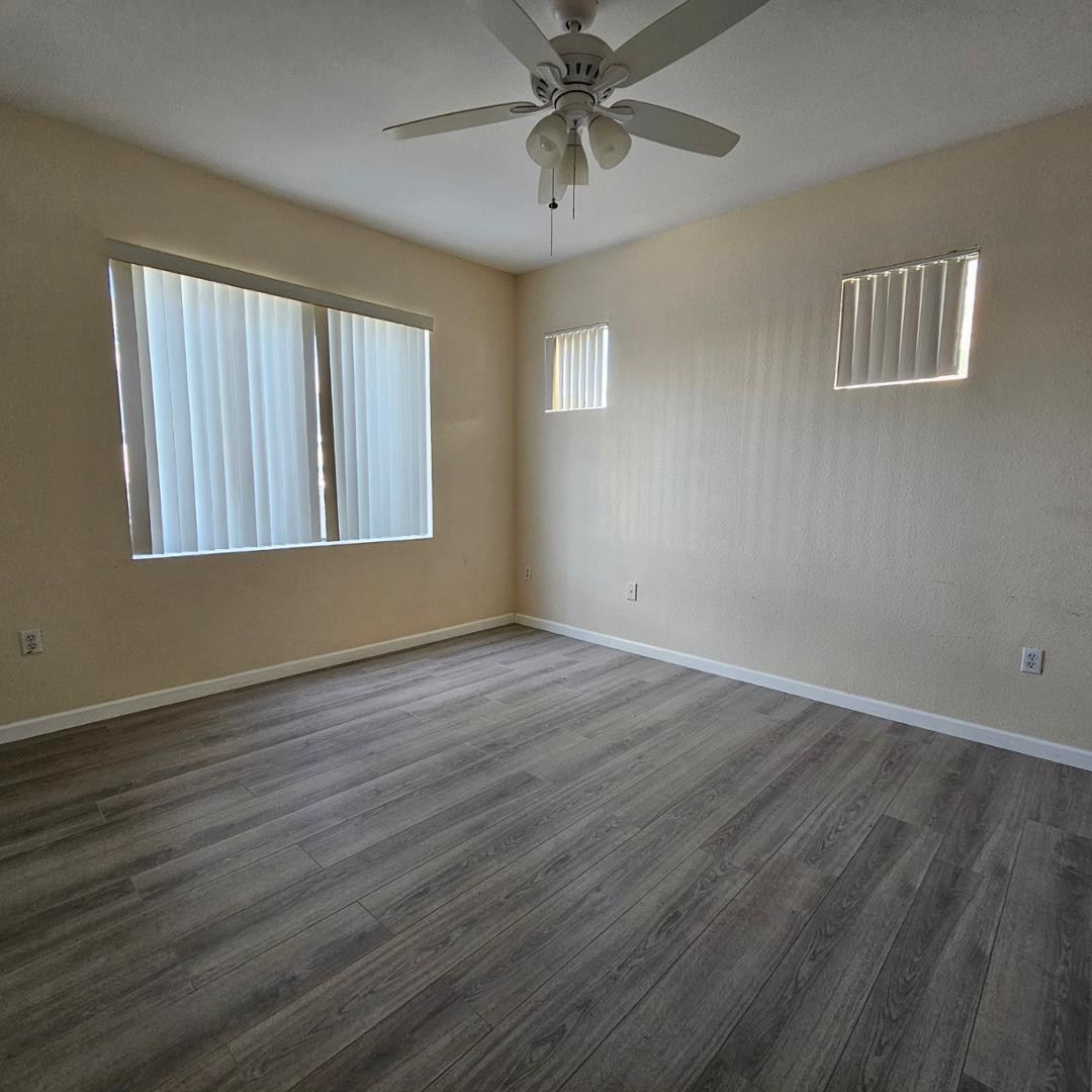 18416 North Cave Creek Road, Unit 2057 Phoenix, AZ 85032 - Photo 5 of 11 a view of an empty room with wooden floor and a window