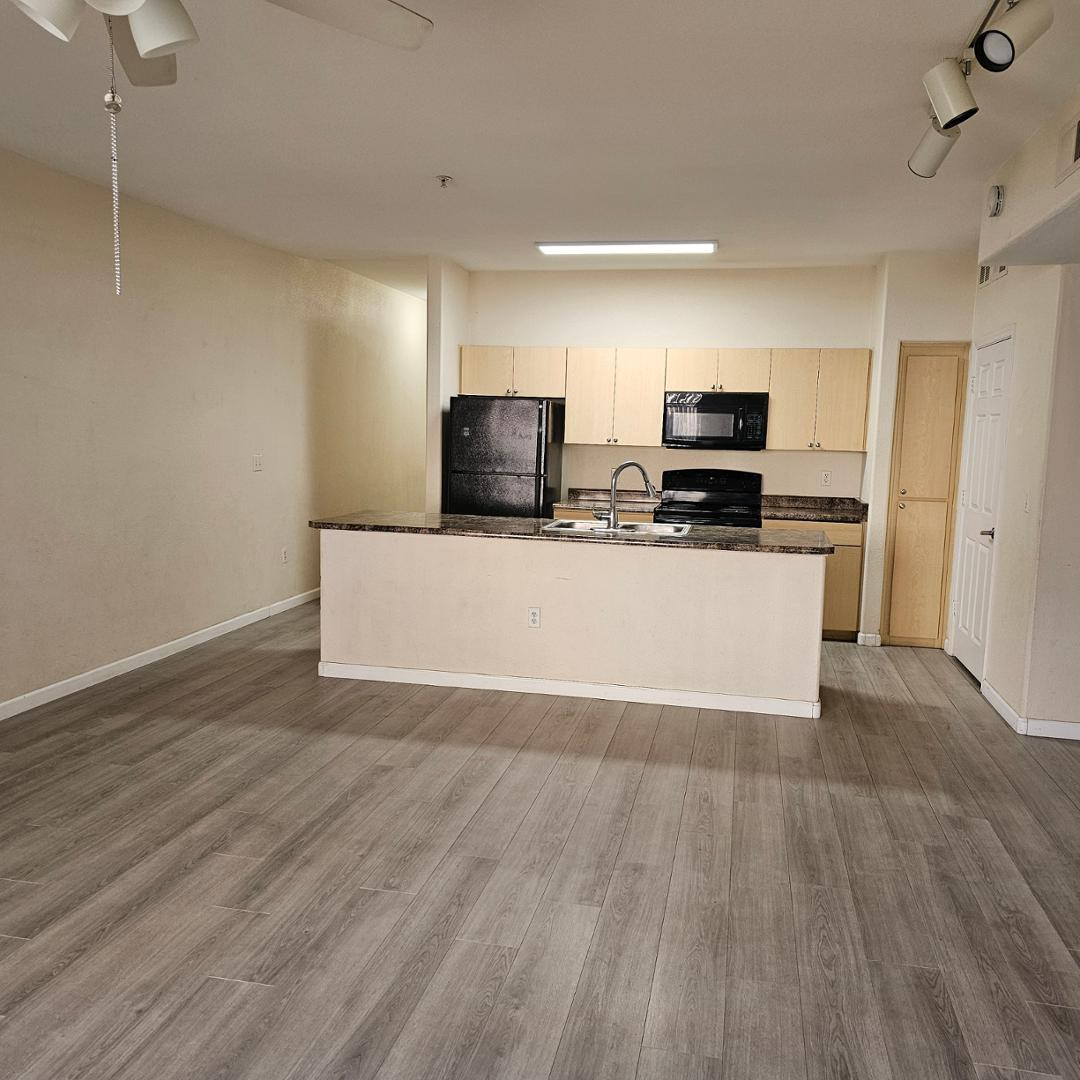 18416 North Cave Creek Road, Unit 2057 Phoenix, AZ 85032 - Photo 8 of 11 a view of kitchen with wooden floor and electronic appliances