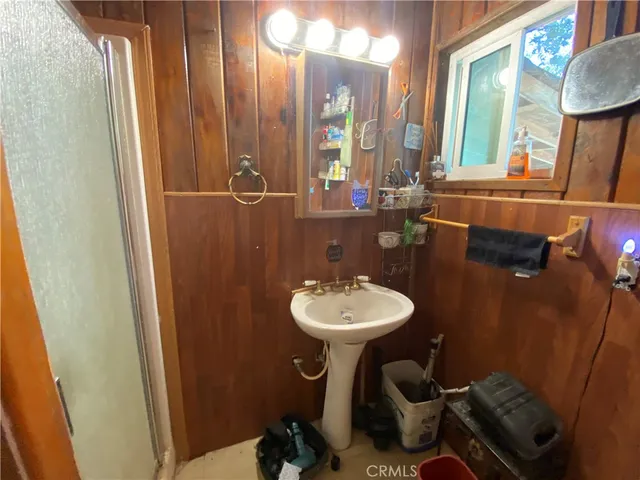 a bathroom with a sink a mirror a toilet and a mirror