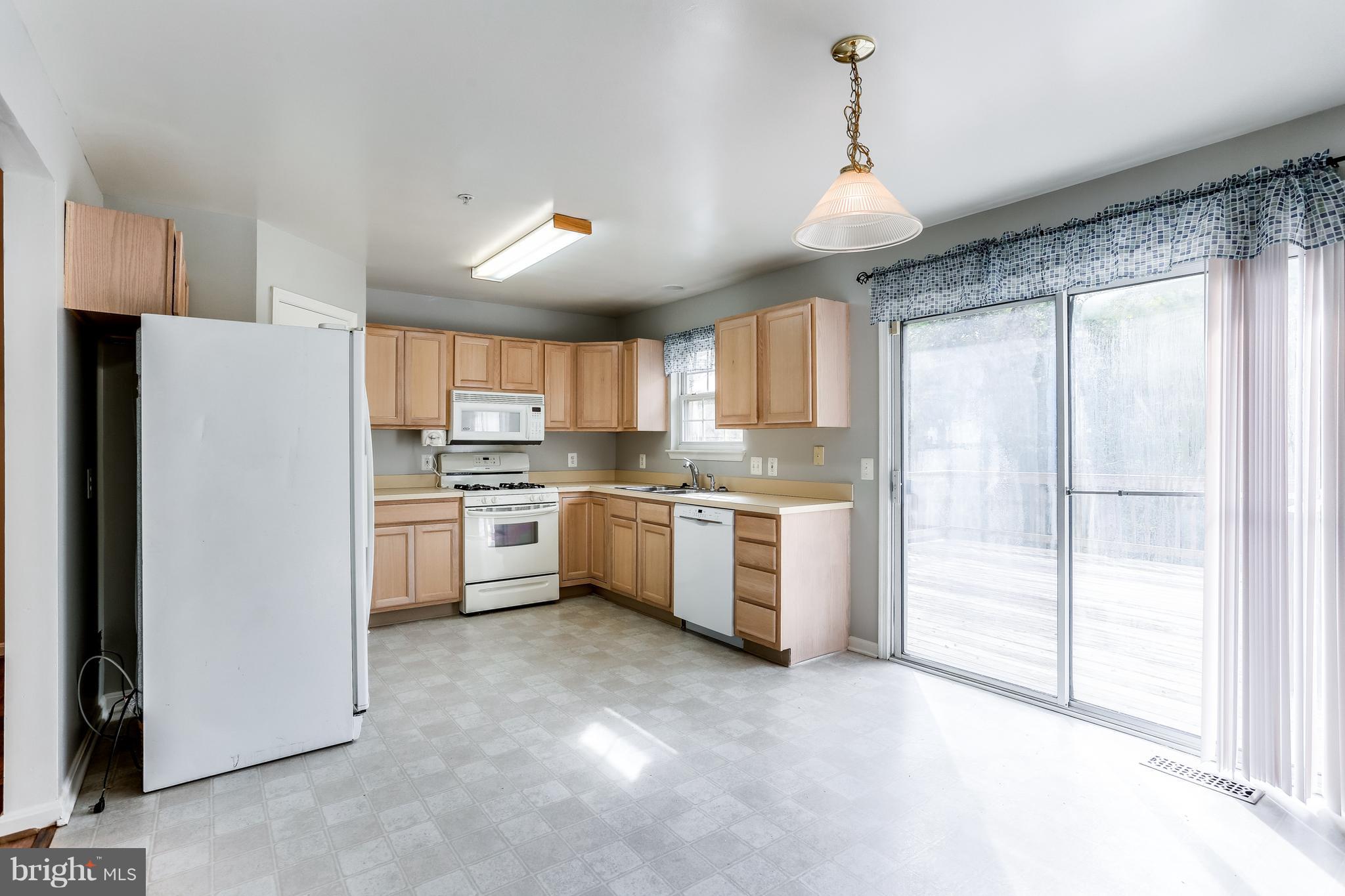 6514 Ridgeborne Drive Baltimore, MD 21237 - Photo 10 of 31 Table-Space Kitchen w/ Sliders to Deck