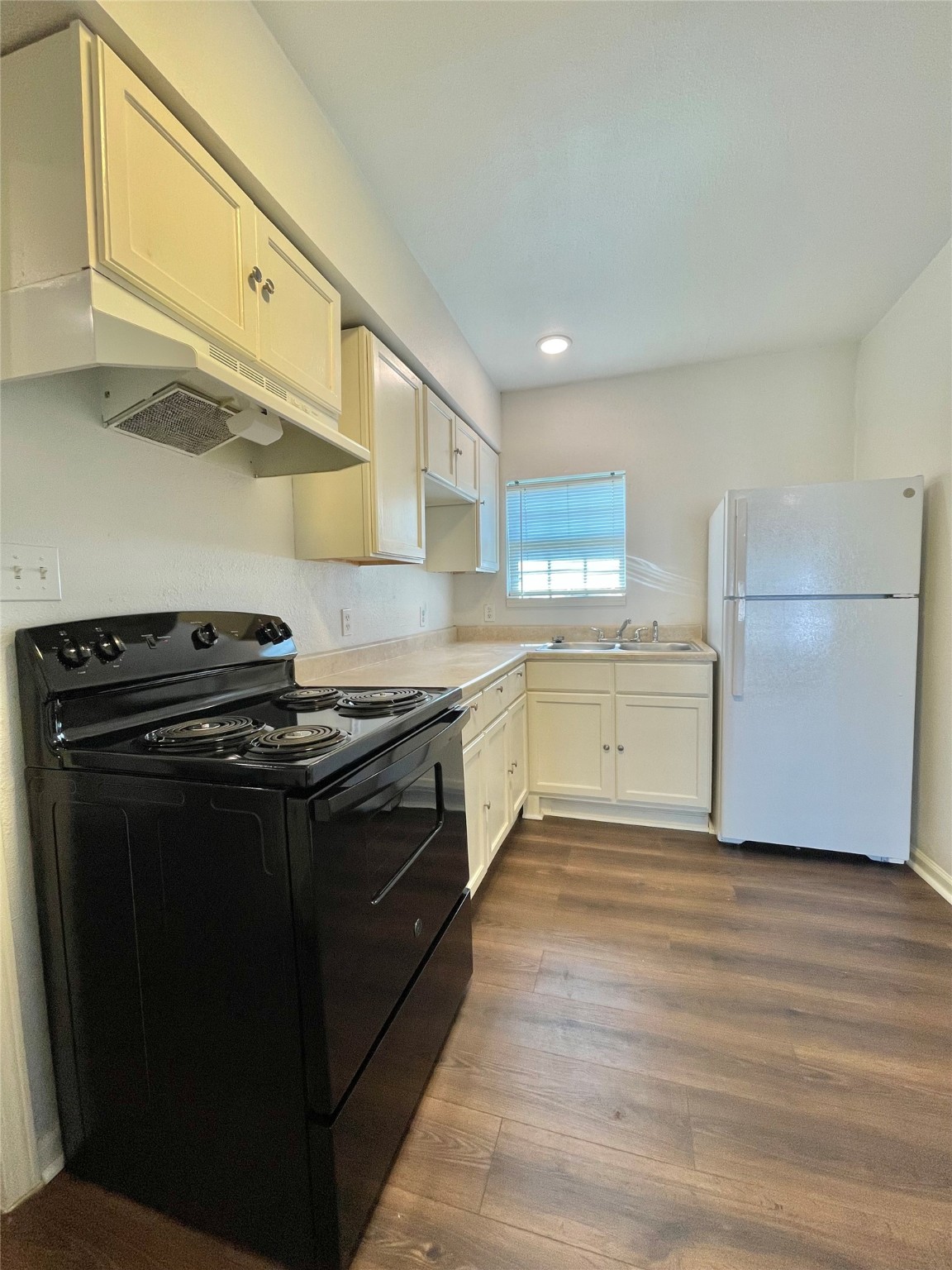 1755 West 6th Street Freeport, TX 77541 - Photo 19 of 19 a kitchen with a stove a sink and a refrigerator