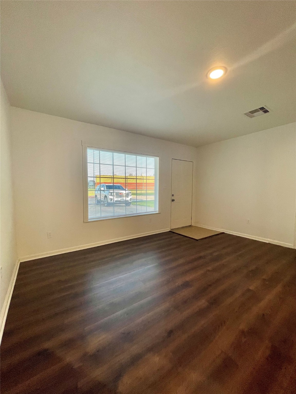 1755 West 6th Street Freeport, TX 77541 - Photo 4 of 19 an empty room with wooden floor and windows