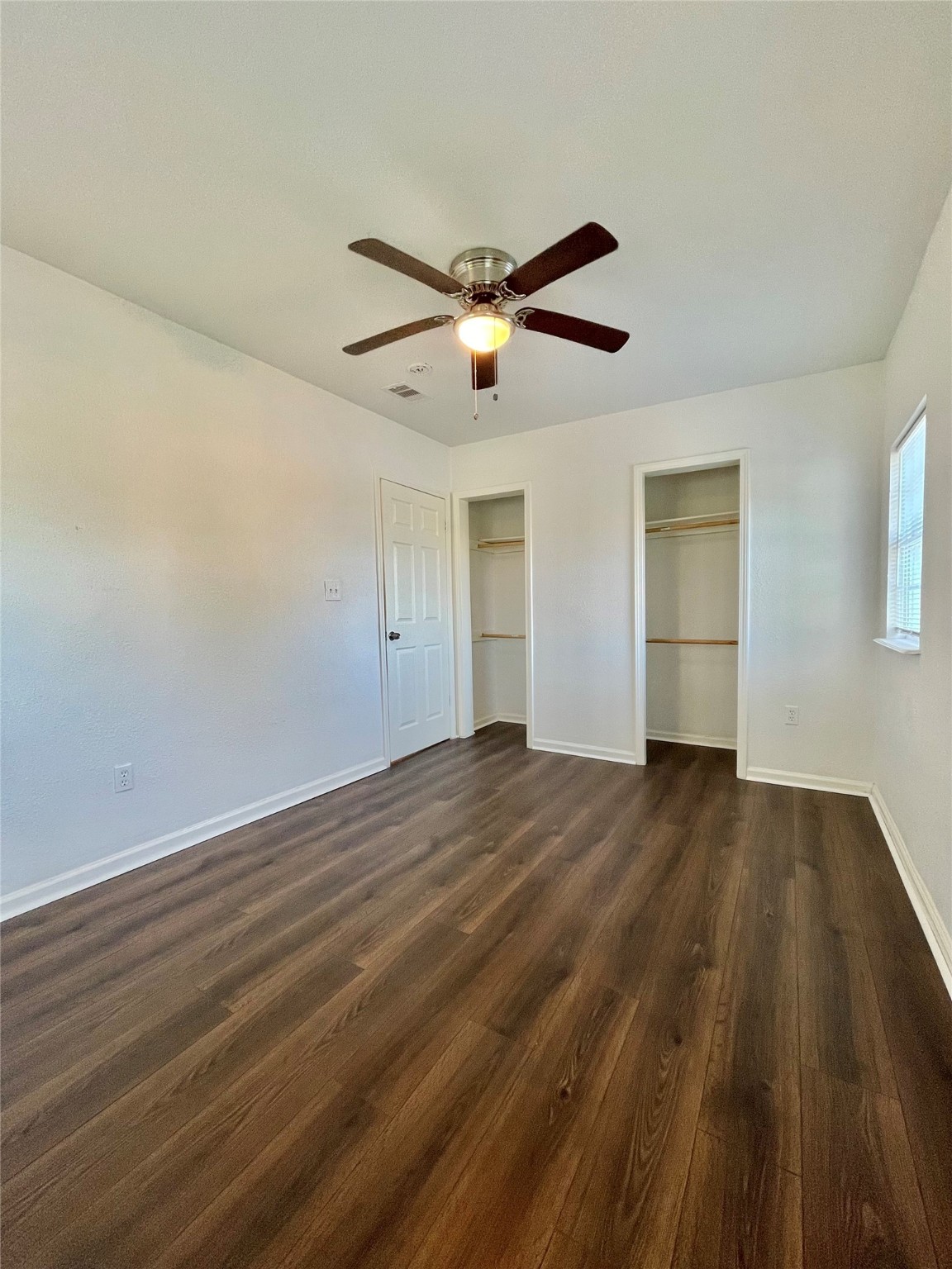 1755 West 6th Street Freeport, TX 77541 - Photo 8 of 19 a view of empty room with wooden floor and fan
