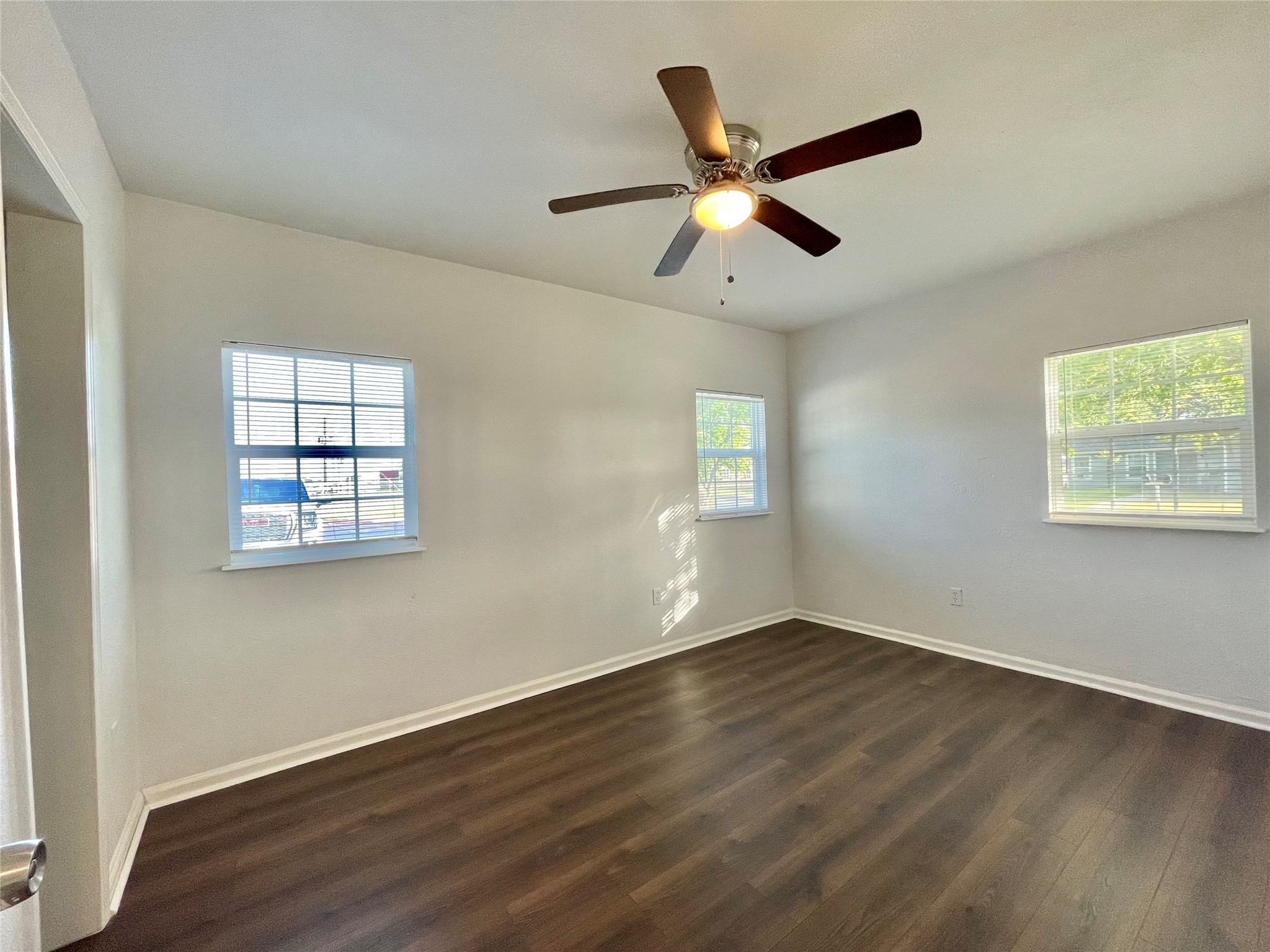 1755 West 6th Street Freeport, TX 77541 - Photo 9 of 19 a view of an empty room with wooden floor and a window