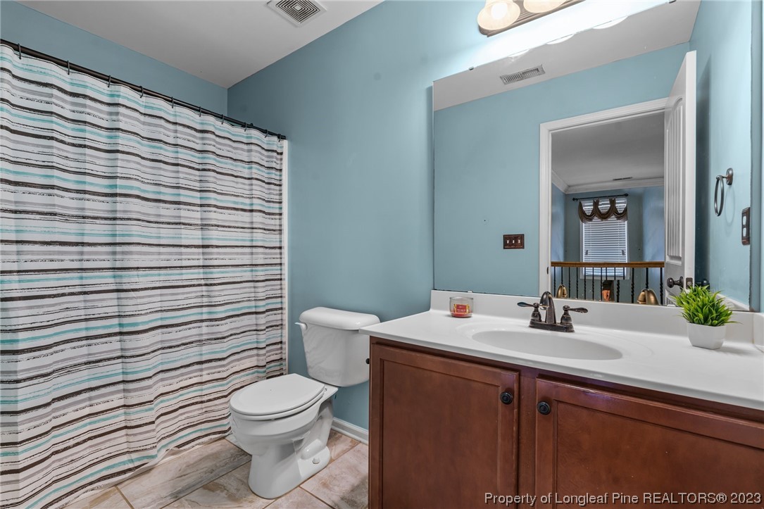 42 Annapolis Road Cameron, NC 28326 - Photo 34 of 43 a bathroom with a toilet a sink and mirror