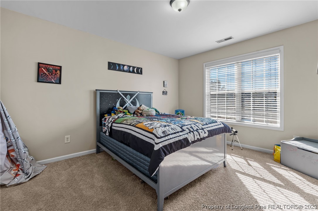 42 Annapolis Road Cameron, NC 28326 - Photo 36 of 43 a bed sitting in a bedroom next to a window