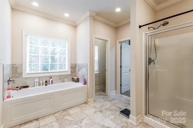 a spacious bathroom with sink shower and a bathtub