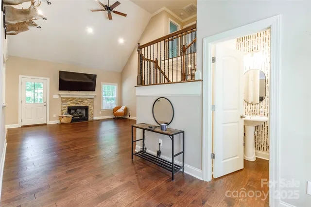 a view of a livingroom with furniture wooden floor window and a fireplace