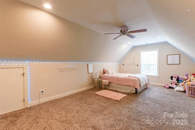 a bedroom with furniture and a chandelier