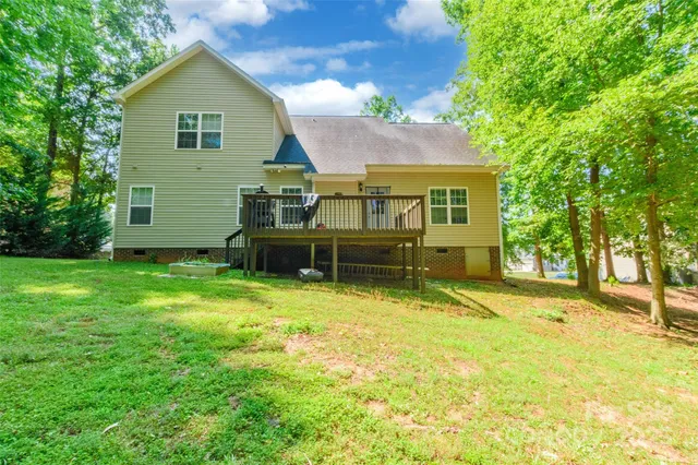 a backyard of a house with yard and trampoline