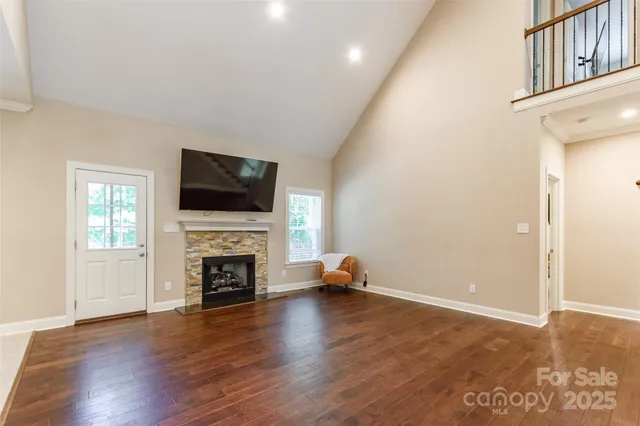 wooden floor fireplace and windows in an empty room
