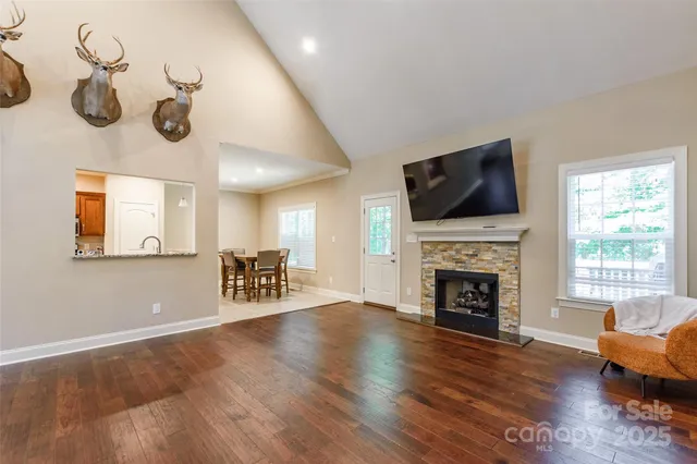 a livingroom with fireplace wooden floor and a couch