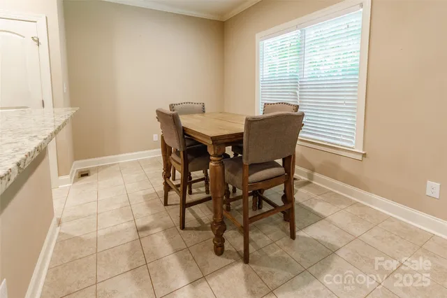 a view of a dining room with furniture and a window