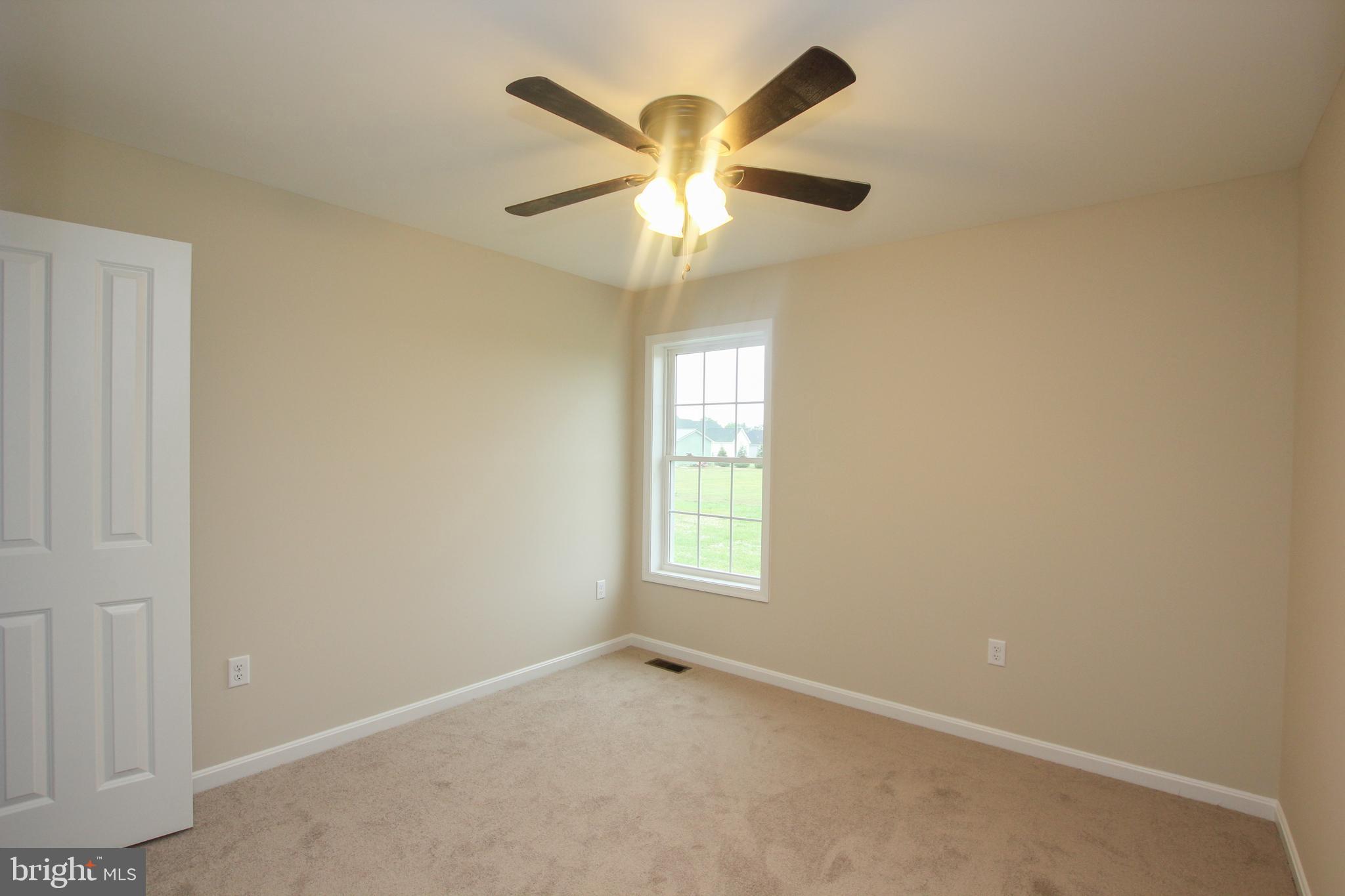 30315 Hawk Rdg Way Seaford, DE 19973 - Photo 18 of 25 an empty room with a window and a fan