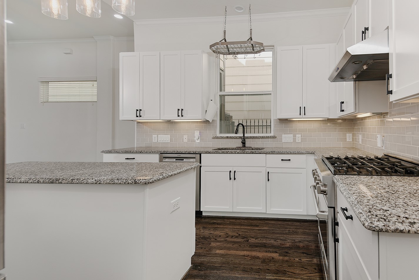 5233 Cornish Street, Unit C Houston, TX 77007 - Photo 11 of 28 a kitchen with granite countertop a sink stainless steel appliances and cabinets