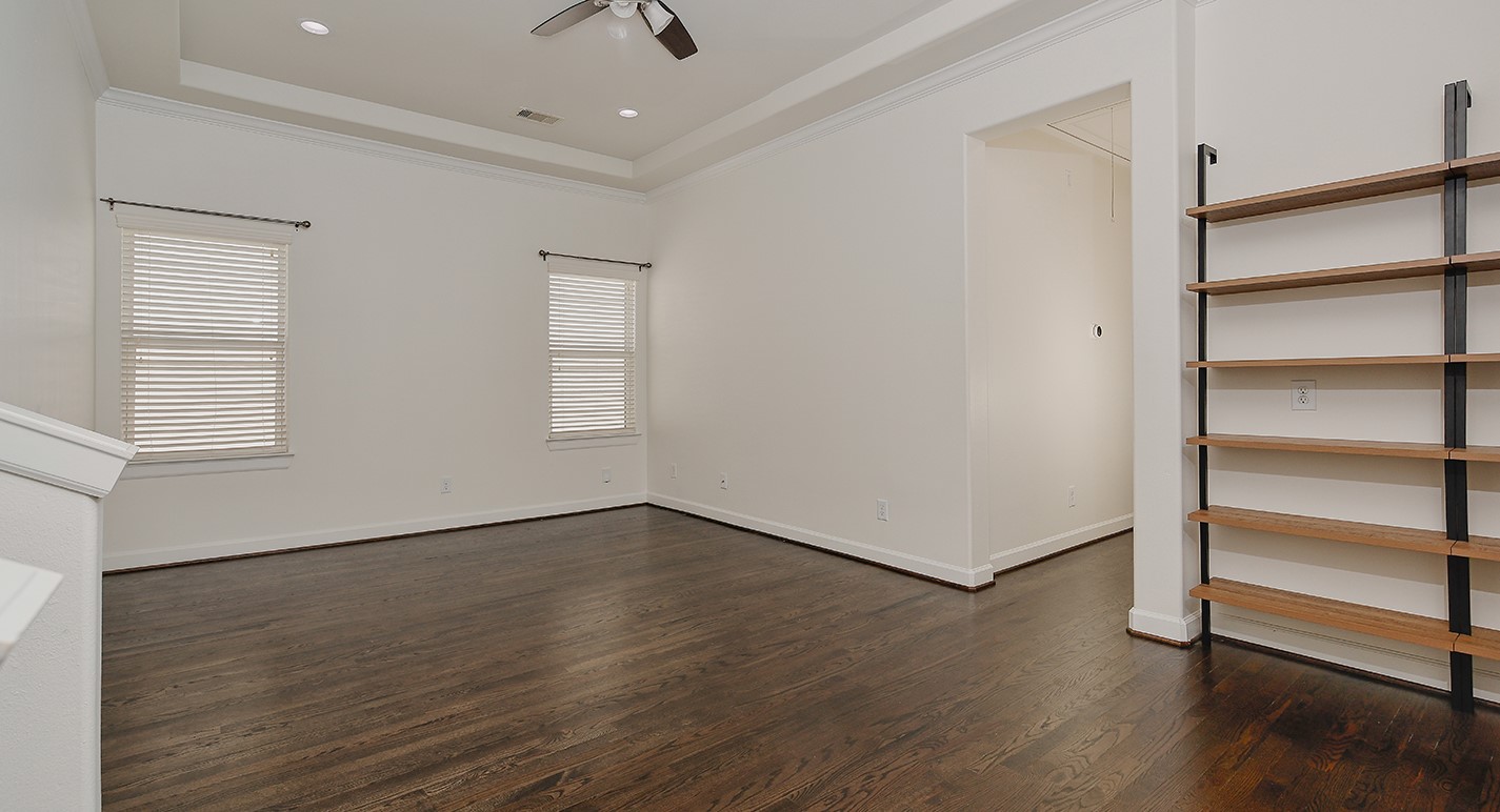 5233 Cornish Street, Unit C Houston, TX 77007 - Photo 14 of 28 an empty room with wooden floor closet and windows
