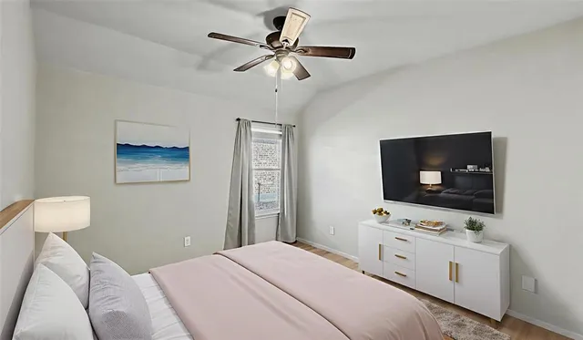 a bedroom with a bed and a flat screen tv